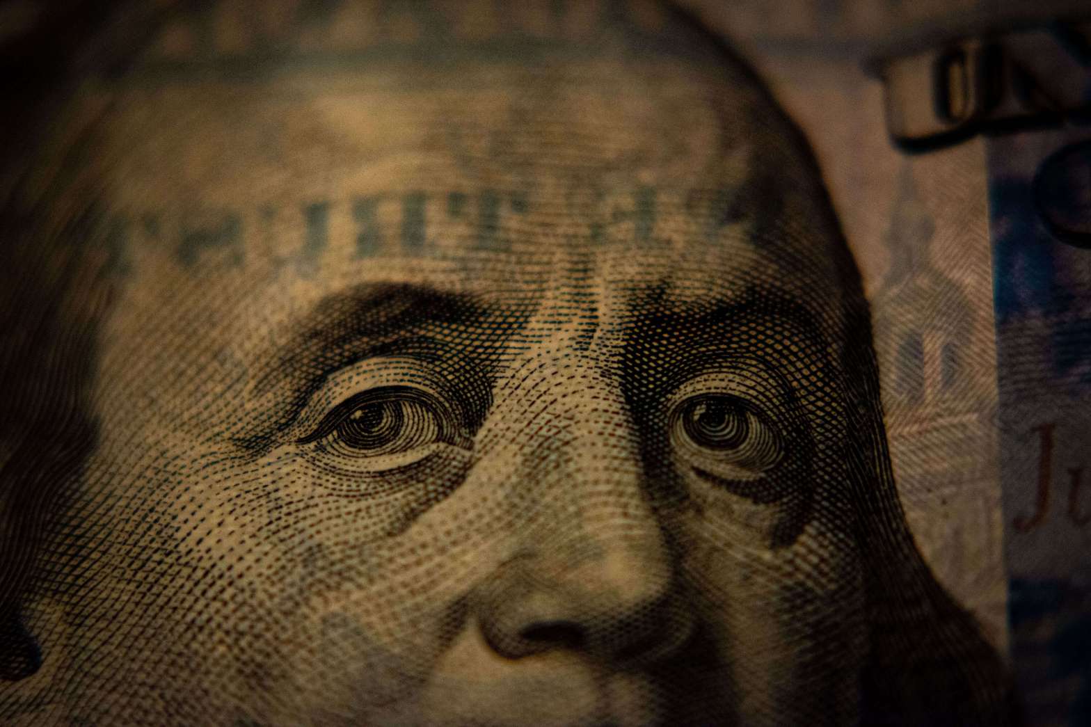 Close up photo of Benjamin Franklin's eyes on the US$100 bill